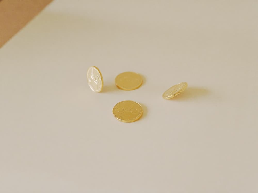 A few gold coins on a bright warm surface
